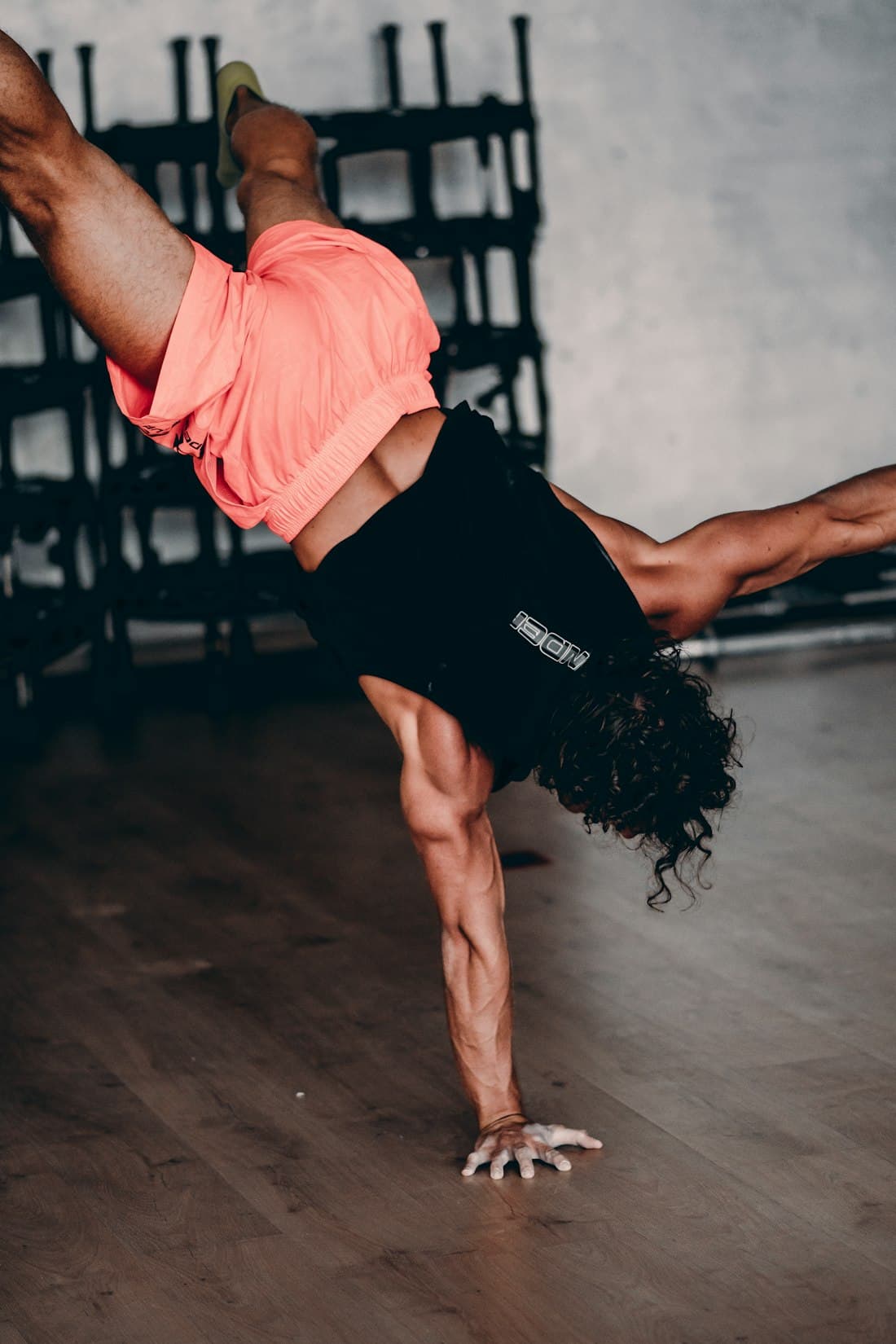 Athlete holding a one-arm handstand